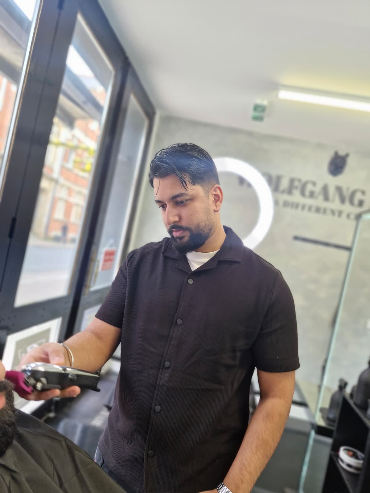 Barber at work with clippers