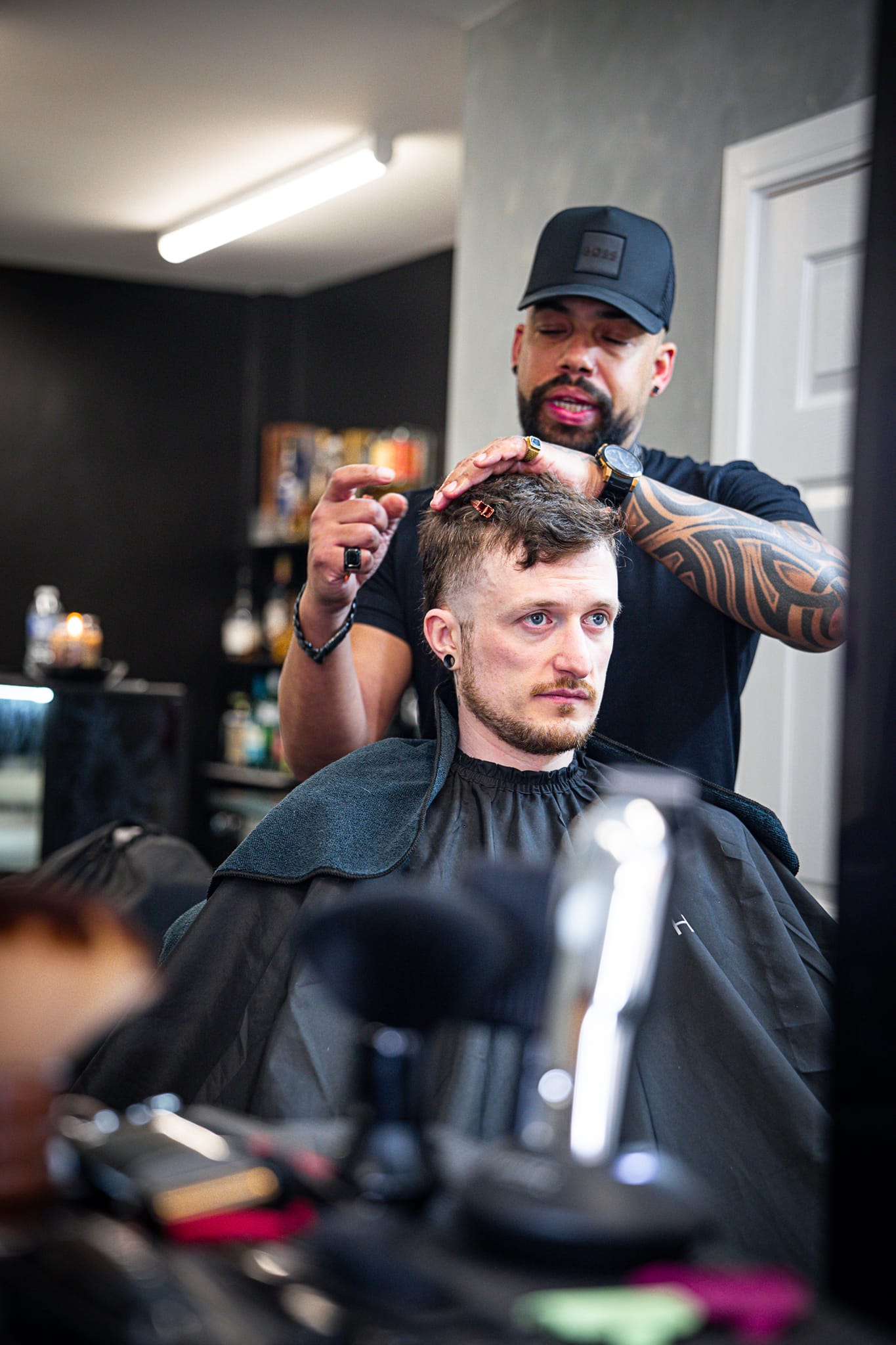 Senior barber styling a finished cut at Wolfgang Hair