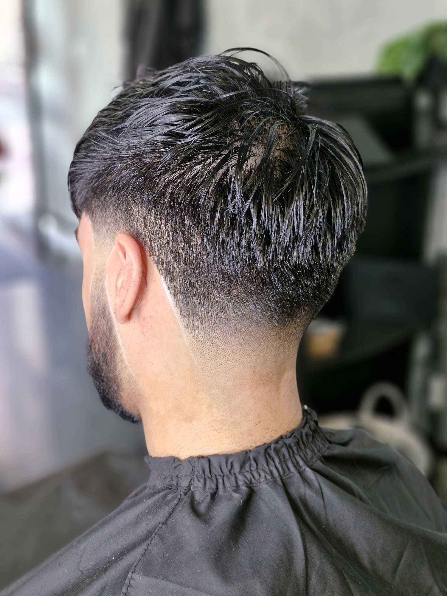 Barber at work with scissors at Wolfgang Hair